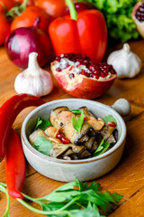 Healthy eggplant rolls stuffed with cheese served in a traditional bowl with a lot of fresh green.