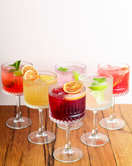 The concept of Georgian cuisine. Cool drinks with ice made of different fruit juice in a glass goblet.