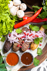 Traditional georgian cuisine. Kupati chashululi chkmeruli roasted sausages. Georgian sausage.