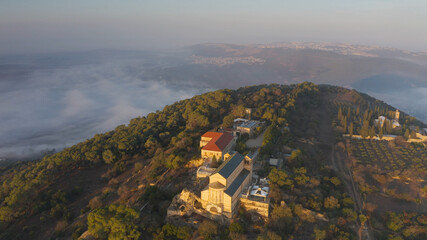 Aerial view over Mount Tavor and Church of the Transfiguration
Drone view from North Israel at sunrise covered with clouds, 2021
