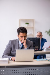 Two male colleagues working in the office