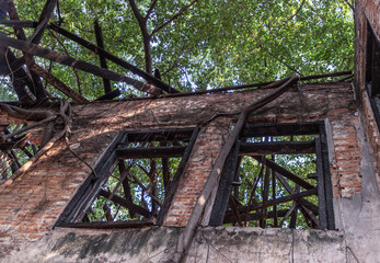 Old wooden windows on the old wall of Abandoned ancient building was left to deteriorate over time....