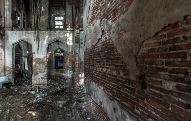 The abandoned building with visible bricks texture was left to deteriorate over time and visible parts of structural elements and ruins. Traditional Architecture style, Selective focus.