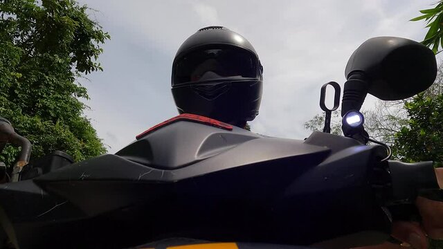 Motor cycle driving -view of handle bar and driver with black helmet - Go Pro mounted angle - On jungle road in Thailand - part 2