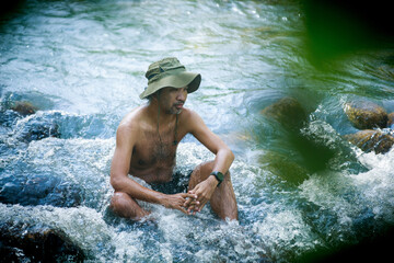 asian old man relaxing in the river