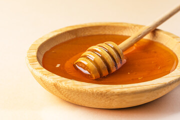 Sweet honey. Healthy organic honey in a bowl with wooden honey dipper.