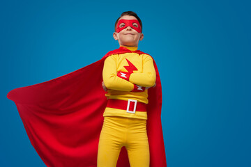 Confident superhero kid in costume and mask © kegfire