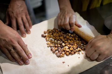 Baker prepares nuts in dough