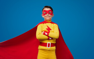 Confident kid in superhero costume and mask