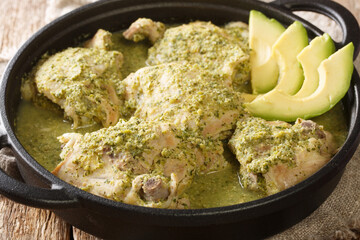 Jocon Recipe Guatemalan Chicken in Salsa Verde with fresh avocado close up in the plate on the table. Horizontal