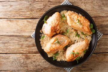 Amish chicken pieces baked in the flour and spices closeup in the plate on the table. Horizontal top view from above