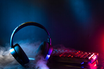 gamer devices for playing game by joystick with computer headphone and mouse on neon glow, gaming...