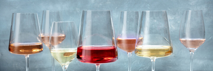 Rose and white wines panorama. Various wine glasses at a tasting at a winery. Winetasting event