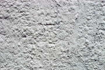 texture of concrete plaster with grooves and cracks.