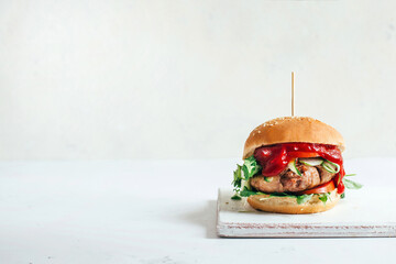 close-up of a burger on a white background with free space for an inscription