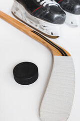 Ice hockey equipment on a white background - skates hockey stick and puck - backdrop on a winter sport theme