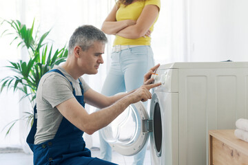 Professional plumber checking a washing machine