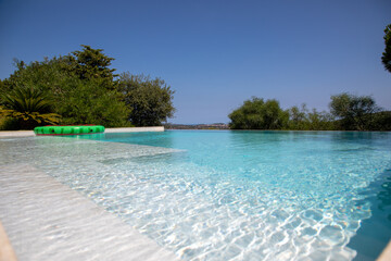 Infinity pool with clear blue water and blue sky