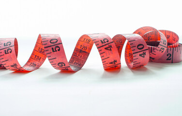 Pink measuring tapes isolated on white background. For fabric cutting, design, text, yours