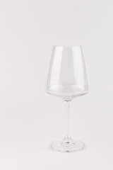 Empty transparent wine glass on the white background