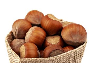 fresh hazelnuts in a canvas bag on white background