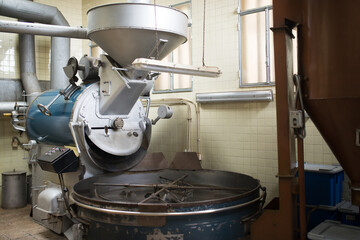 Coffee roasting equipment. Interior of coffee production workshop with set up roasting machine. production, industry, manufacturing process concept