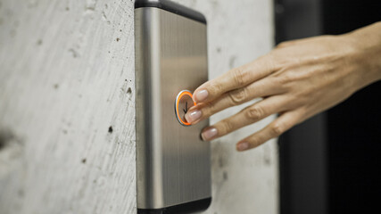 Female hand pressing elevator button, woman in office building, destination © Synthex