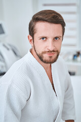 Handsome dark-haired male client in a wellness center