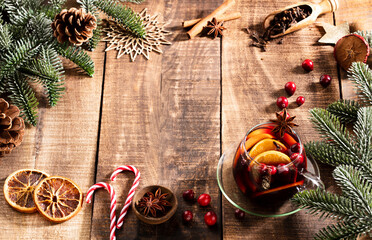 Christmas mulled wine with spices on a wooden rustic table.