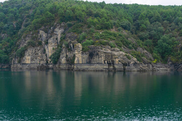 Landscape of a mountain with marks on the rock from the water level of the lake