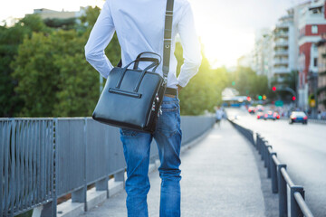 detail young african american executive man with briefcase and white shirt walking in the street