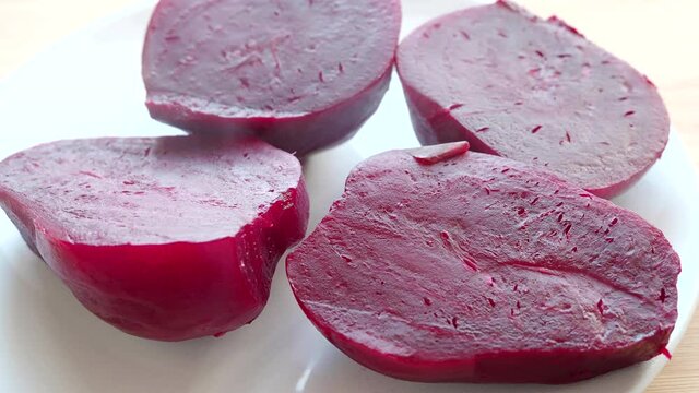 Close-up of a boiled beet, cutted beet with steam on a plate, video 4k resolution
