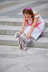 cute little girl on roller skates at park.