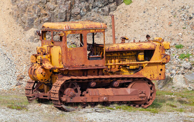 Old rusty crawler tractor with shovel