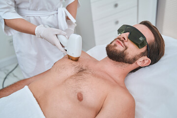 Spa client undergoing a medical procedure performed by a dermatologist - obrazy, fototapety, plakaty