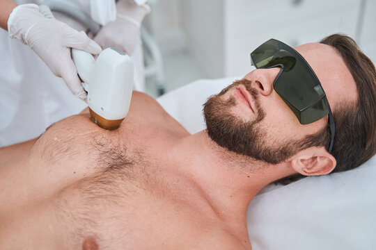 Beauty salon customer undergoing a laser chest hair removal