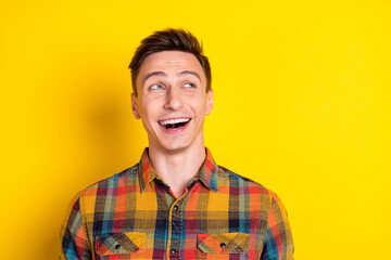Obraz premium Portrait of attractive curious cheerful brown-haired guy laughing thinking copy space isolated over bright yellow color background