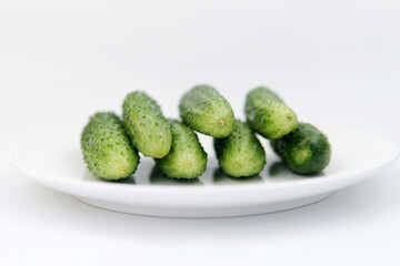 cucumbers on a plate on a white background