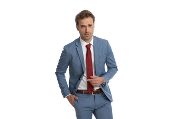 sexy young businessman in blue suit holding hand in pocket