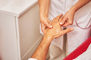 Naklejka premium Cosmetologist brushing the back of client hand with thumb