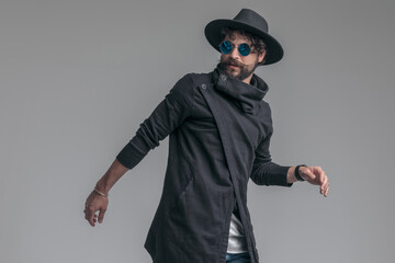 casual man looking away and wearing sunglasses and a hat