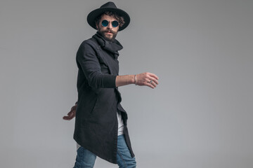 sexy casual man walking one way and looking the other