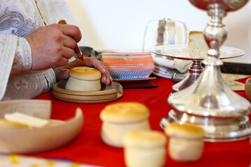 During the liturgy, the Orthodox priest performs the rite of proscomedy on the throne of the Orthodox Church. The hands of a priest. The concept of the Orthodox faith.