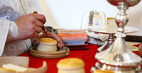 During the liturgy, the Orthodox priest performs the rite of proscomedy on the throne of the Orthodox Church. The hands of a priest. The concept of the Orthodox faith.