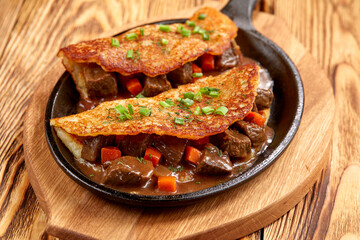 potato pancake with meaat on the pan