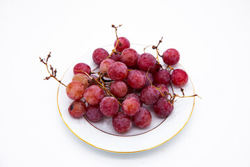 Bunch of red grapes. Summer and cocktail fruit. Delicious grapes. Fresh grapes on branches. Appetizing grapes.