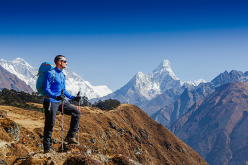 Hiker with backpack enjoying the Ama Dablam mountain view view Everest trek in Himalayas. Success,...