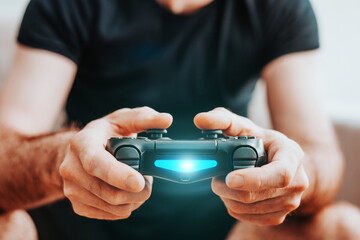 Man gambling with a game console - gamepad in hands - adult child