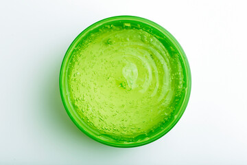 Cosmetic gel in a jar on a white background. Green transparent gel with texture and bubbles isolate