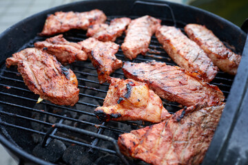 Grilled pork chop and vegetables on the flaming grill.